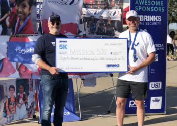 Volunteers holding check