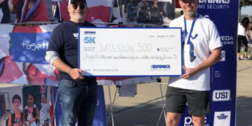 Volunteers holding check